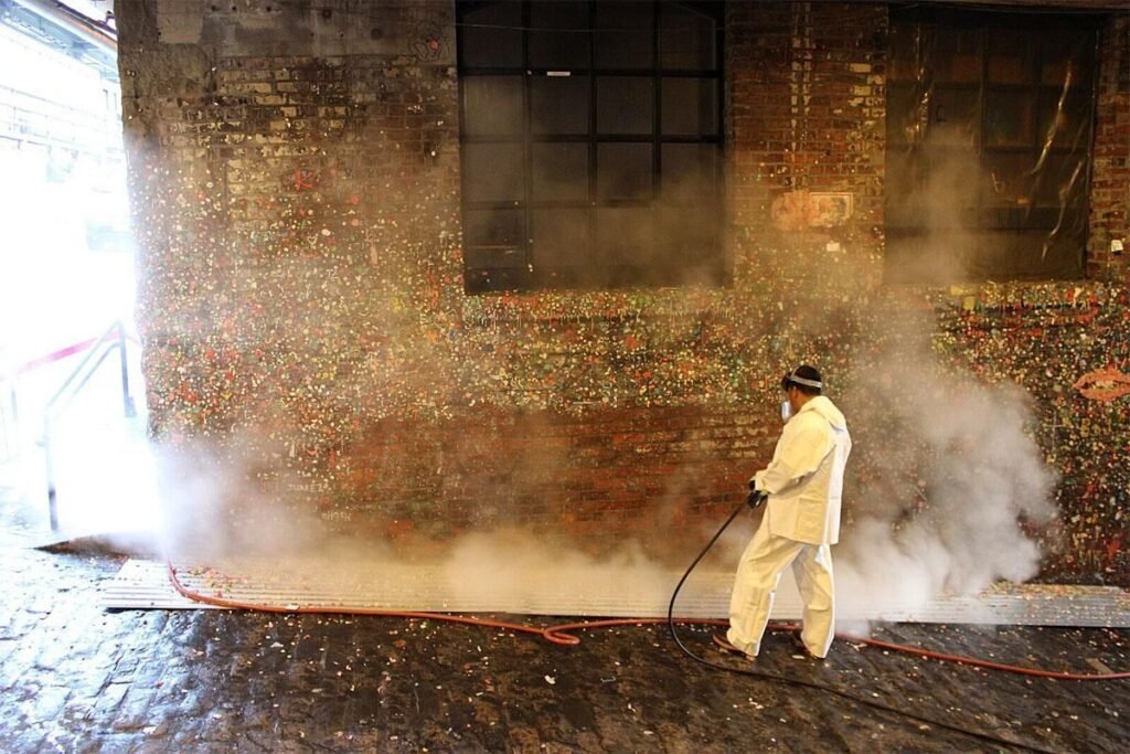 Seattle Gum Wall being steam cleaned to remove gum buildup