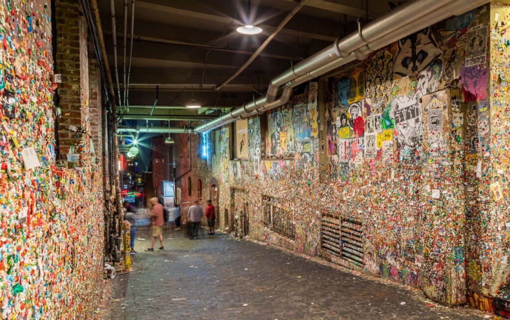 Night view of Seattle Gum Wall in Post Alley with visitors