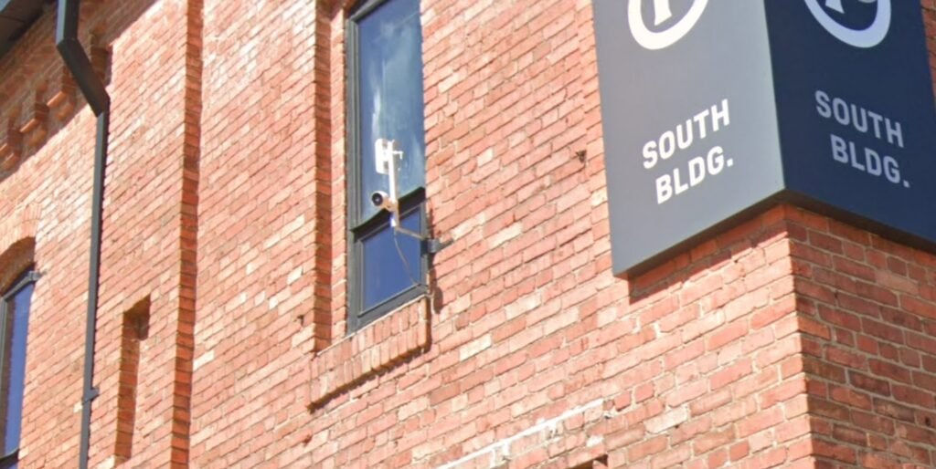 A camera mounted on the brick wall of the South Building at Brightleaf Square, one of the vantage points used by Jürgen Henn to film the 11foot8 Bridge.