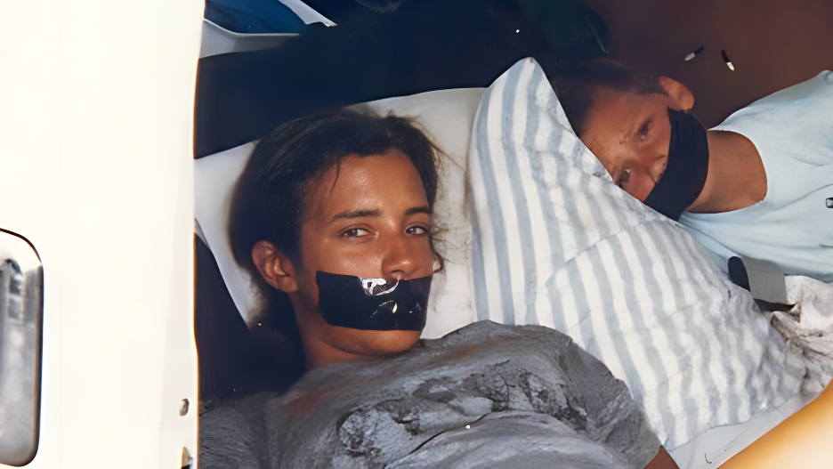 A mysterious Polaroid photograph showing Tara Calico and boy with duct tape over their mouths, lying on a bed believed to be linked to a chilling unsolved case.