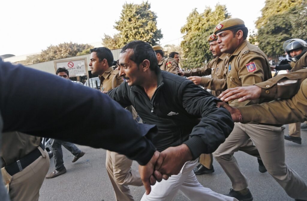 A chaotic arrest symbolizing the breakdown of law and order that culminated in the infamous Akku Yadav court killing by a mob of vengeful women.