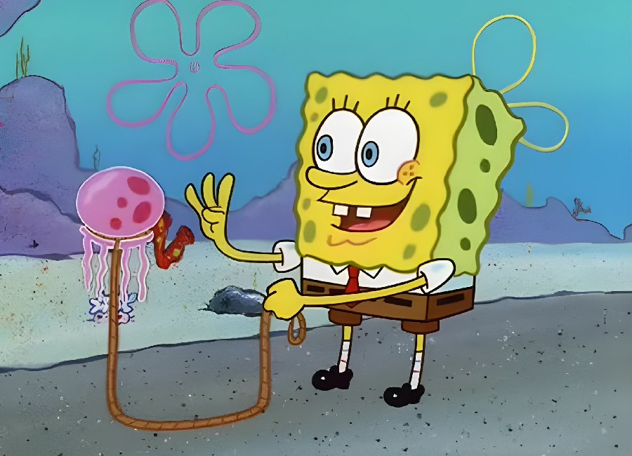 SpongeBob SquarePants holding a jellyfishing net with a jellyfish floating beside him under the sea.