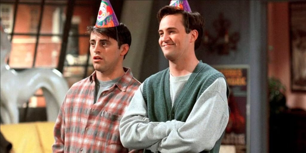 A heartwarming and funny image of best friends Joey and Chandler wearing party hats, perfectly capturing the comedic chemistry that made their friendship a fan favorite.