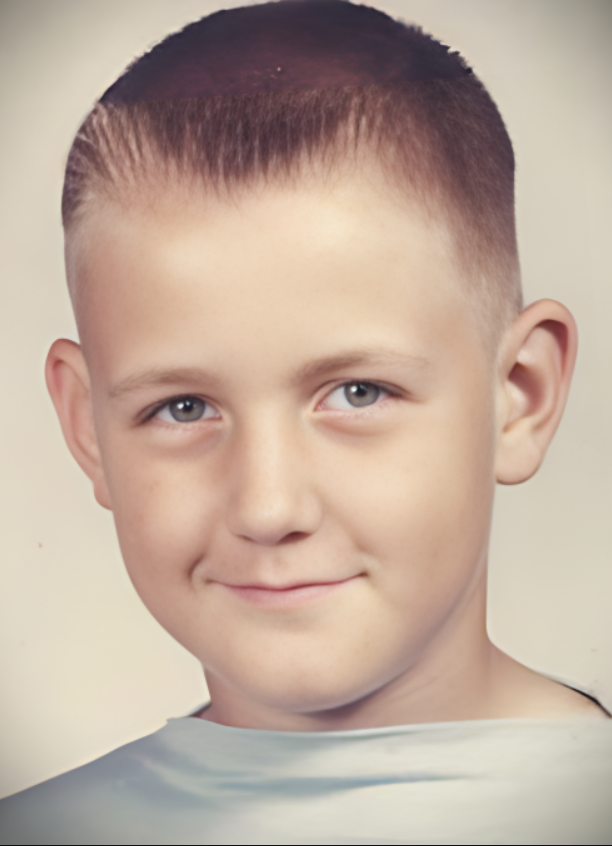 A color school portrait of a young Terry Bollea, who would become Hulk Hogan, with a short, flat-top haircut, smiling at the camera.