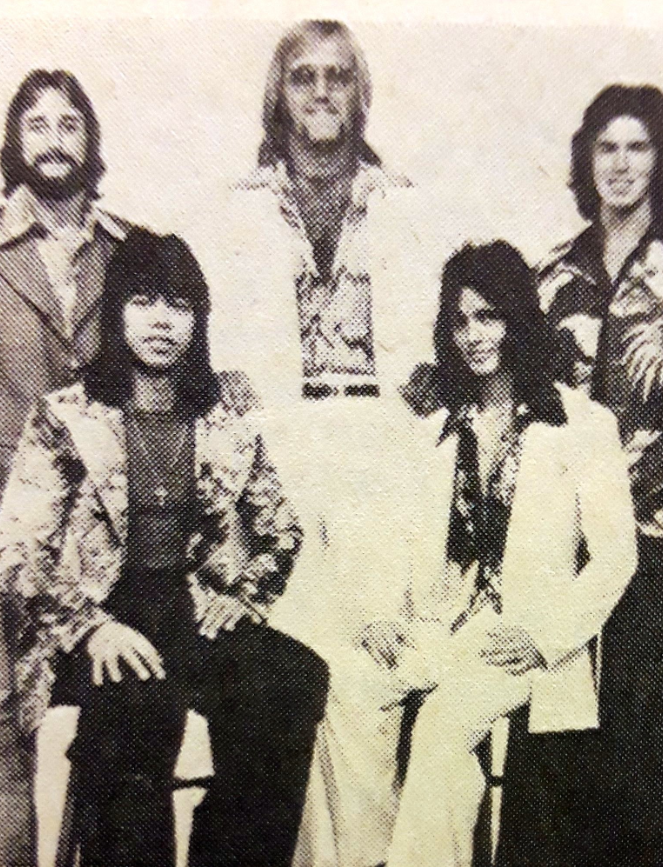 A young Hulk Hogan (back, center) with long blonde hair, posing with his 1970s rock band, Ruckus, before his wrestling career.