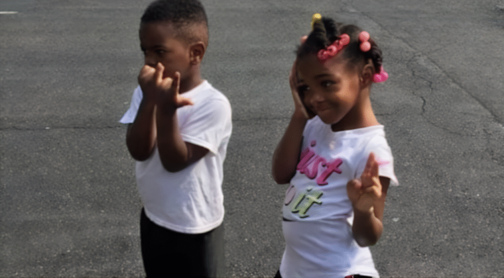 he two young children of Nicole Michelle Johnson standing outdoors.