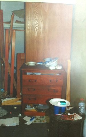 The squalid and cluttered living conditions inside Mitchelle Blair's apartment, showing extreme neglect.